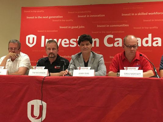 Unifor President Jerry Dias seated with bargaining team.